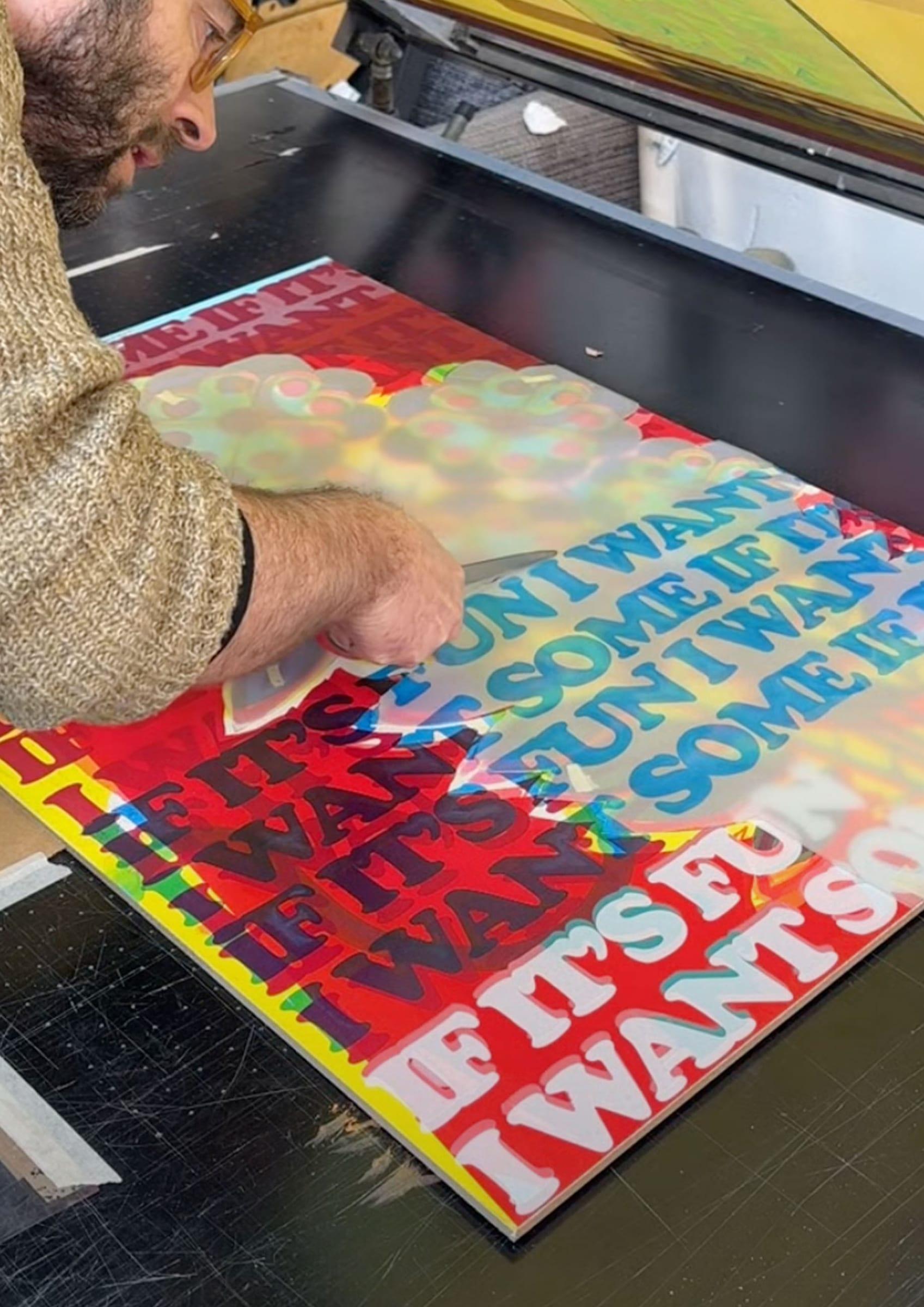 Lifting the corner of a wet print with a blade