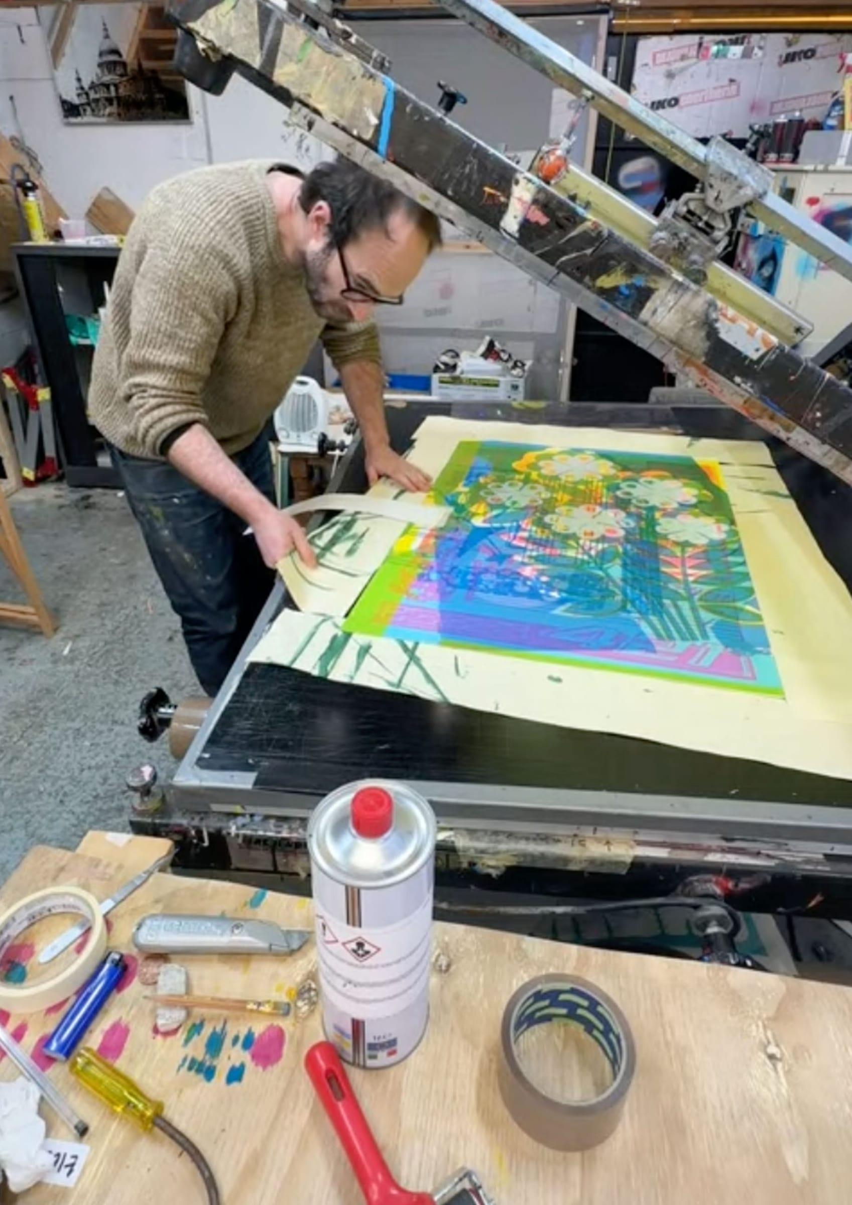 Lifting a finished floral print off the press bed