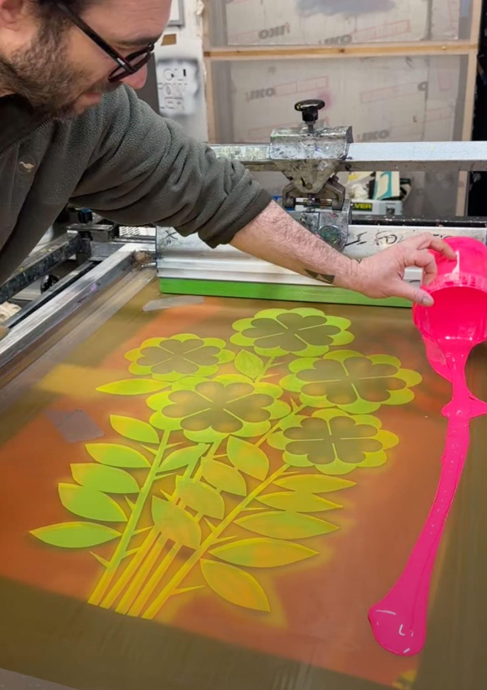Pouring hot pink ink onto the exposed screen